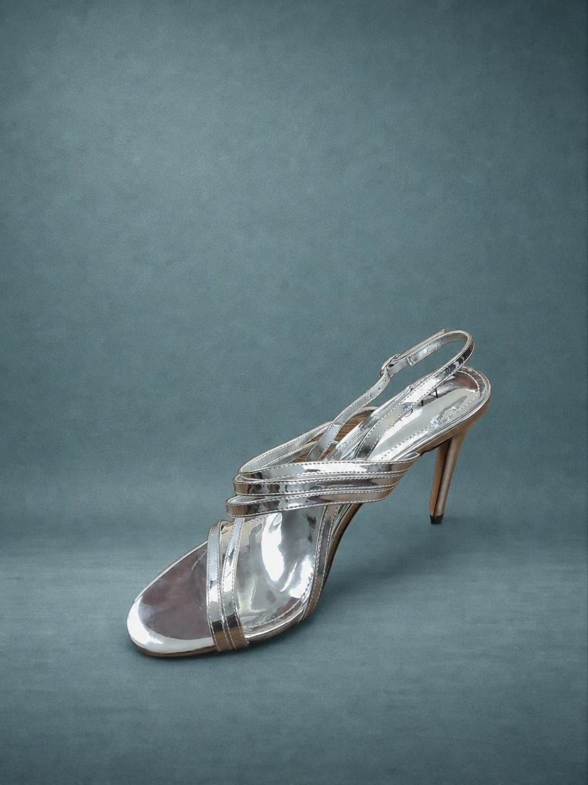 Seller-ready silver high heel product image on a studio backdrop after Portrait Drop Professional Studio Finish