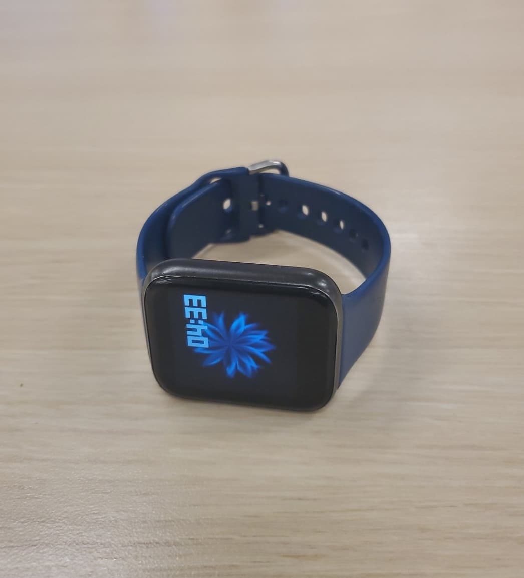 Raw Android phone product photo of a smart watch on a wooden table before Portrait Drop